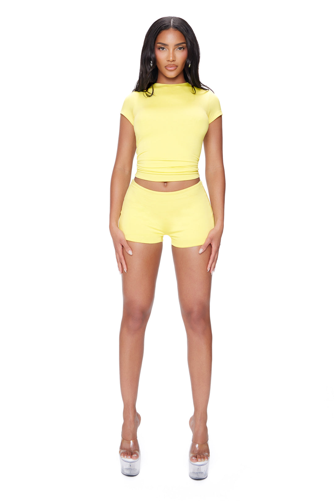 Woman wearing a yellow outfit on a white background