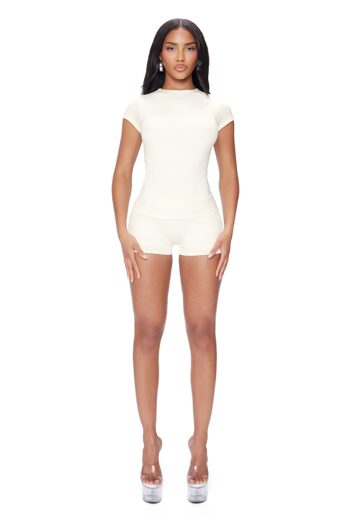 Woman wearing a white two piece on a white background