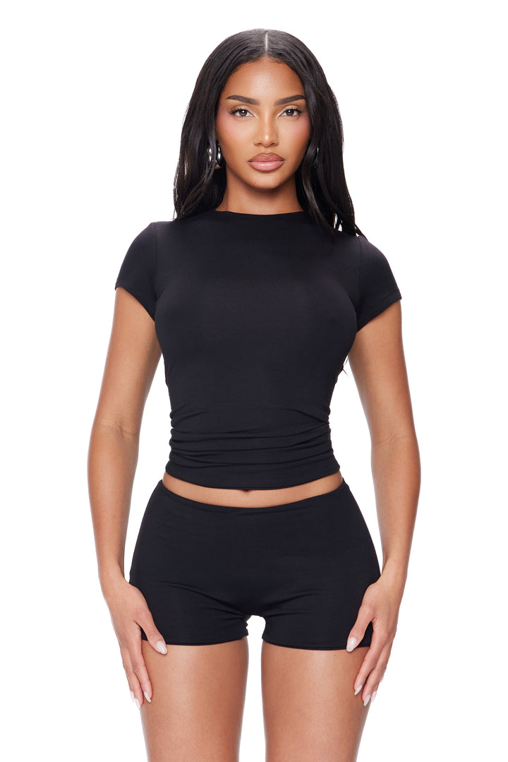 Woman wearing a modal top and shorts on a white background
