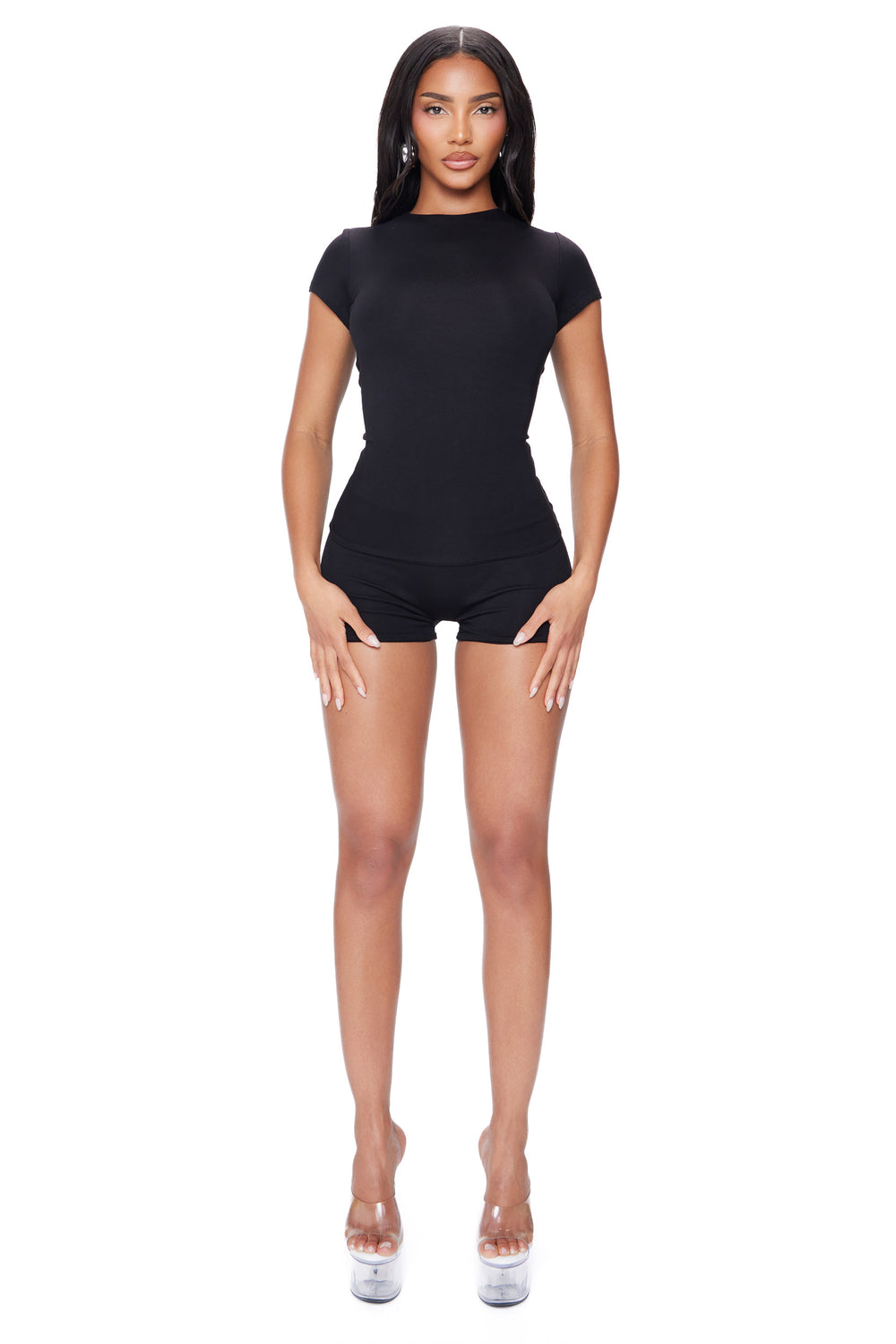 Woman wearing a black outfit on a white background